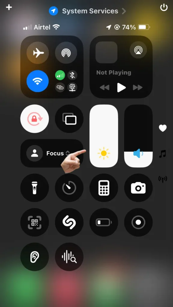 iPhone Control Center: Brightness slider at 100%